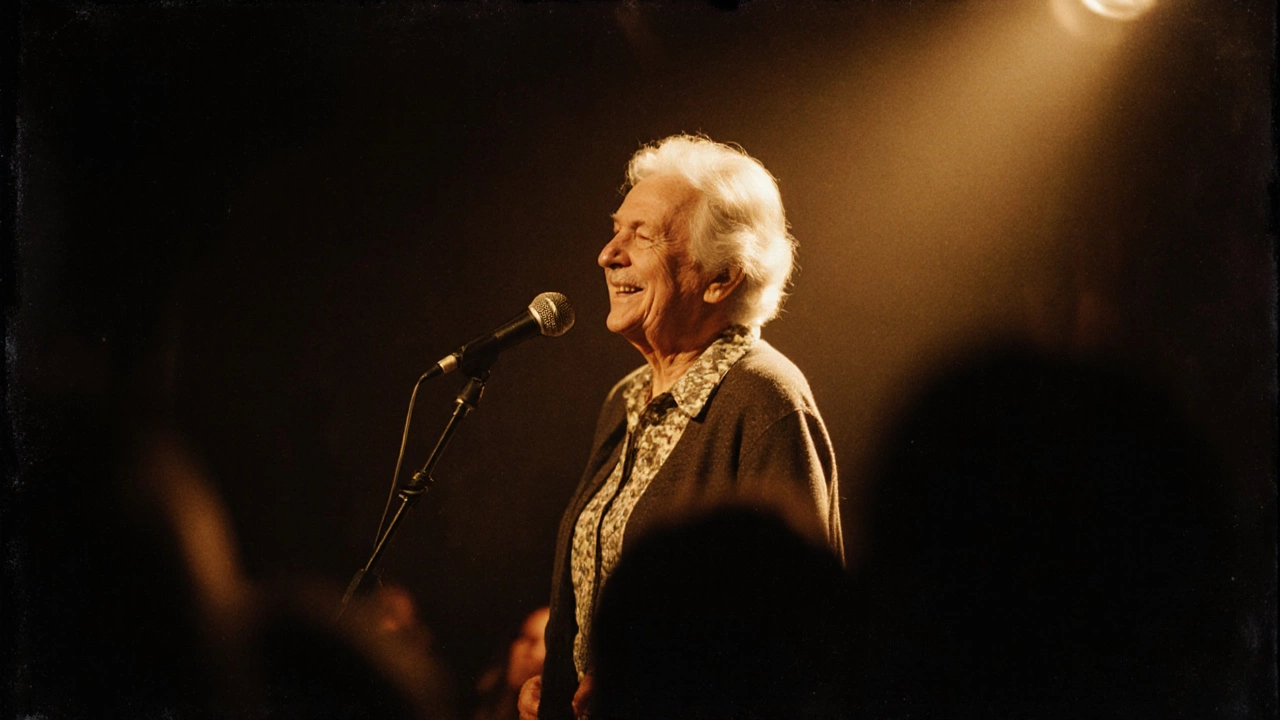 An older woman speaking confidently at an open mic night, softly lit by a spotlight.