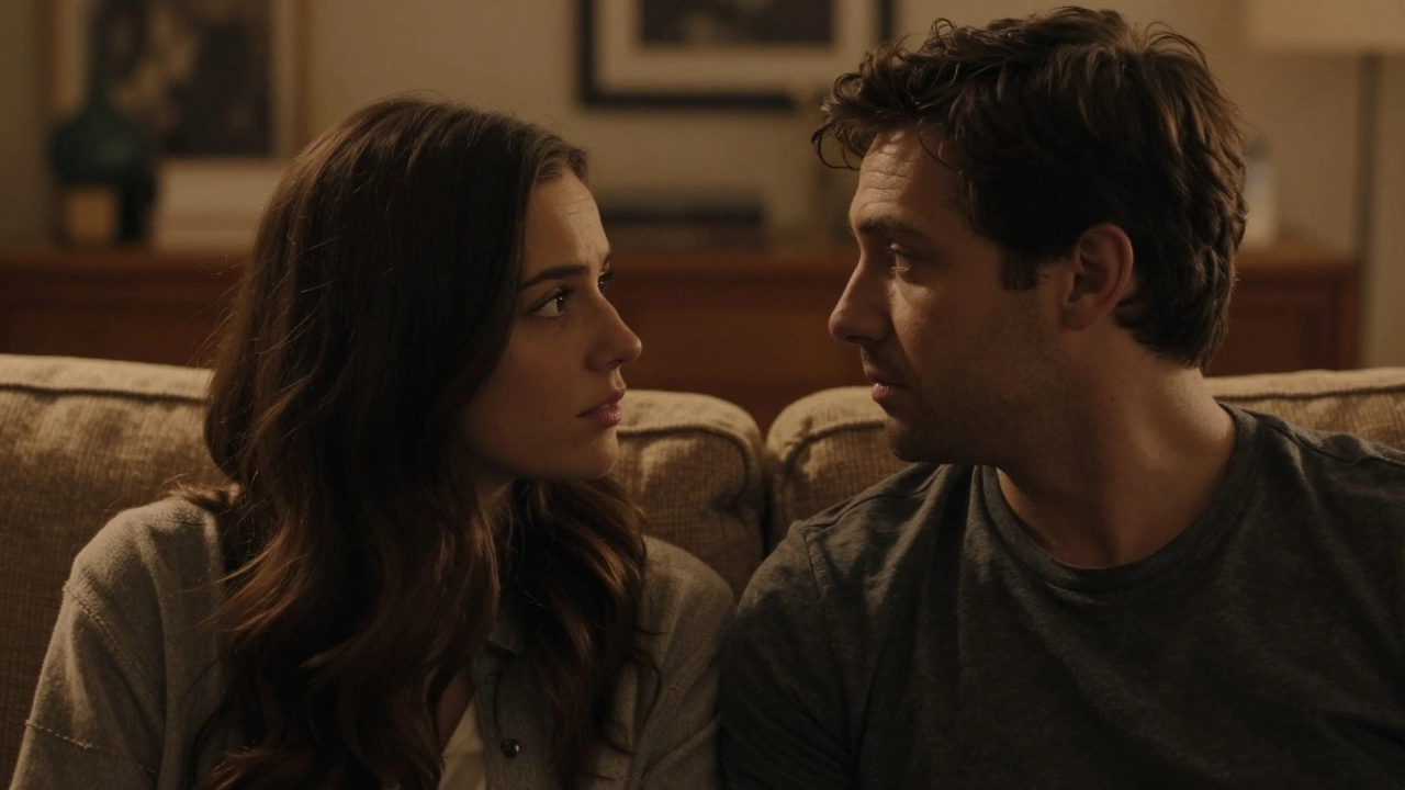 Man and woman listening empathetically on a couch in warm lighting