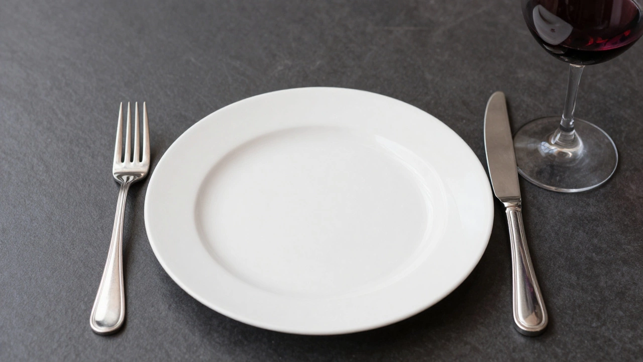 Close-up of properly arranged cutlery and wine glass on a formal dining plate.